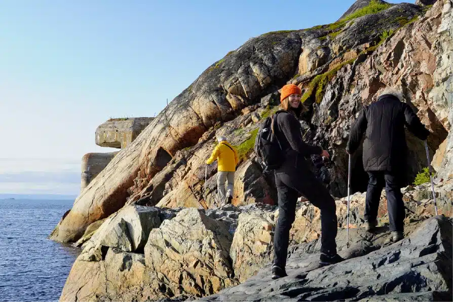 Hikers arriving at the abandoned WWII torpedo battery near Kirkenes