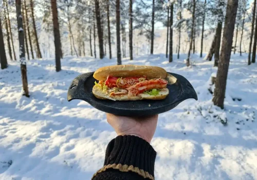 Tasty King Crab rolls served outdoors in a snowy forest near Kirkenes in Northern Norway.